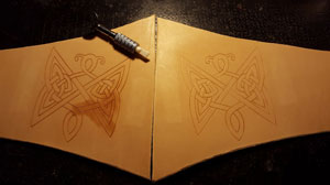 using a ceramic blade to carve the design into the leather